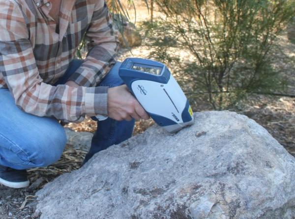 S1 TITAN, portable XRF taking an analysis of rock