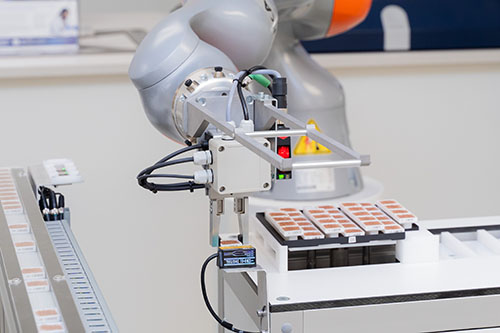 Robotic arm preparing samples for micro XRF analysis